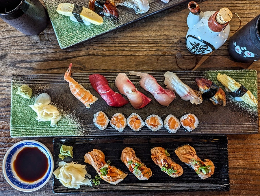 Overhead view of sushi, including a simple maki and some nigiri.